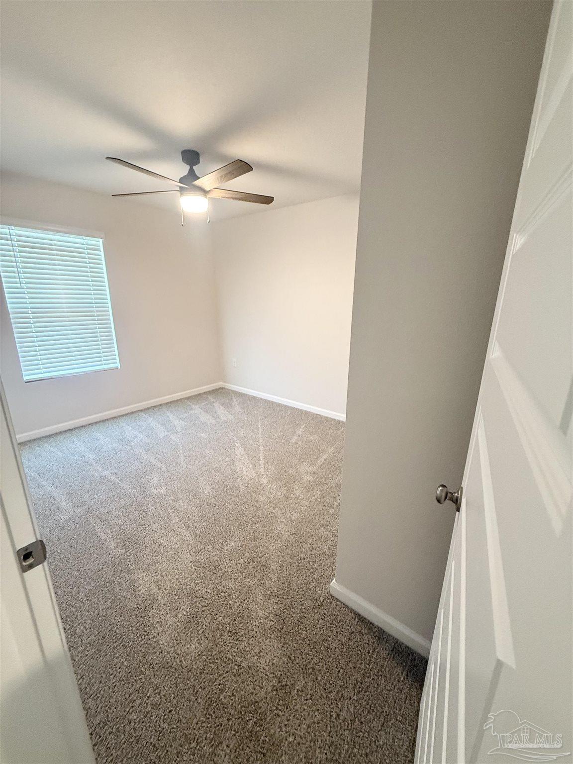 4335 Redbay Court Pace, FL 32571 - Photo 6 of 30 an empty room with windows and fan