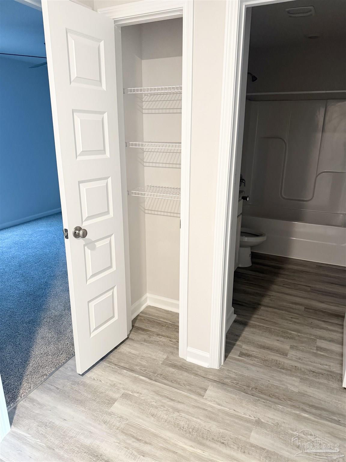 4335 Redbay Court Pace, FL 32571 - Photo 8 of 30 a view of a hallway with wooden floor and closet