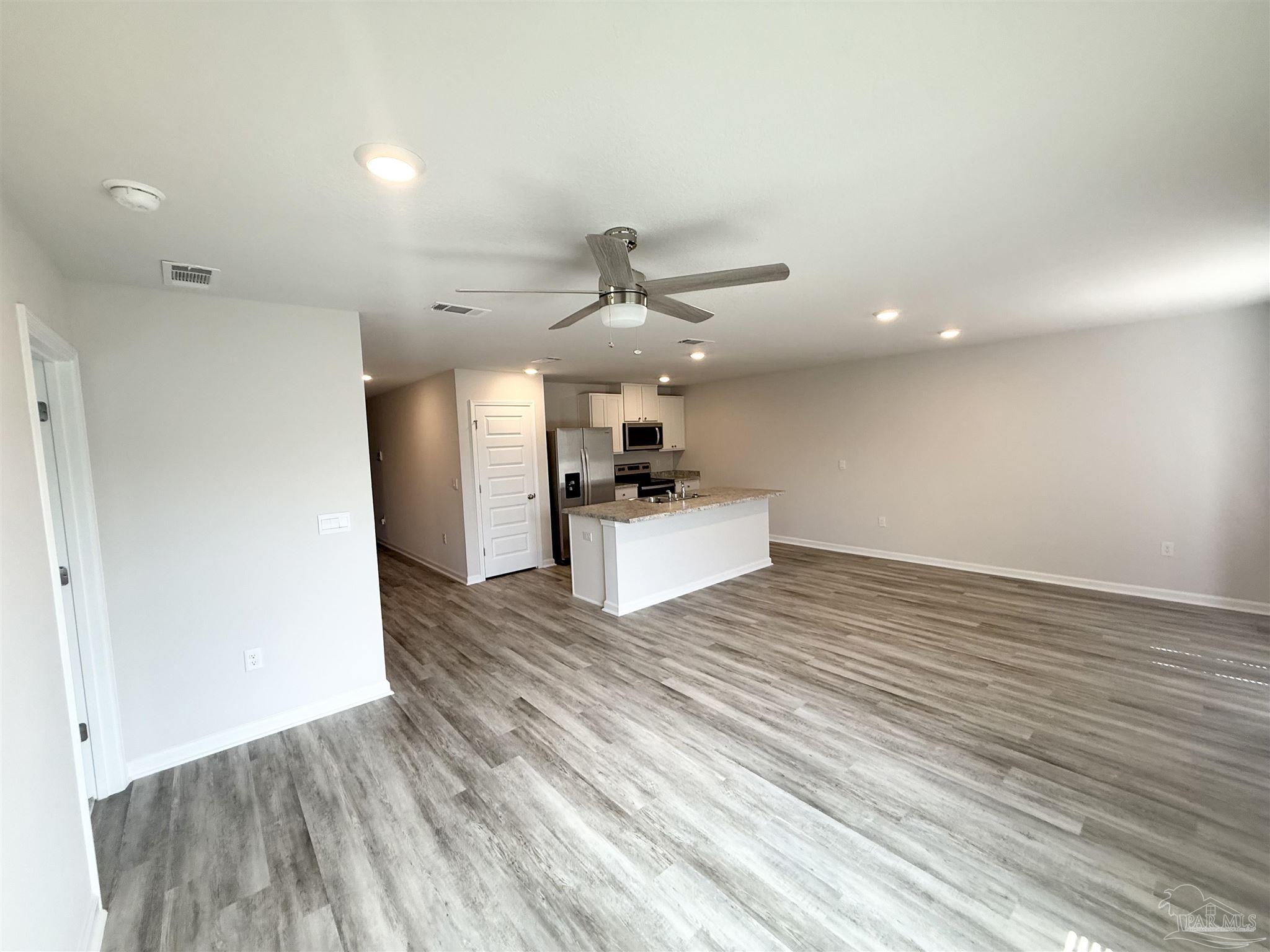 4335 Redbay Court Pace, FL 32571 - Photo 10 of 30 a view of a kitchen with a sink and a refrigerator
