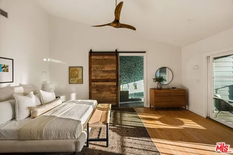 a bedroom with a large bed and a window