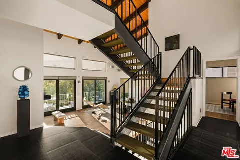 a view of front door with dining room and stairs