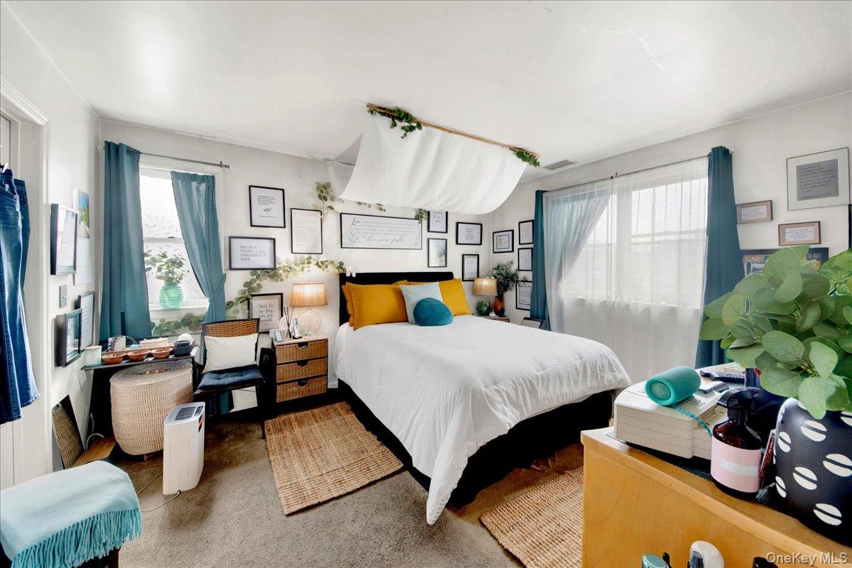 37 Harbor Lane, Unit 2A New Rochelle, NY 10805 - Photo 12 of 22 a bed room with a bed and large windows