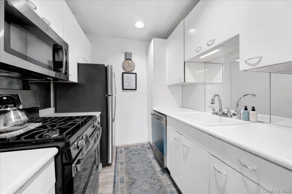 37 Harbor Lane, Unit 2A New Rochelle, NY 10805 - Photo 8 of 22 a kitchen with stainless steel appliances granite countertop a sink stove and refrigerator