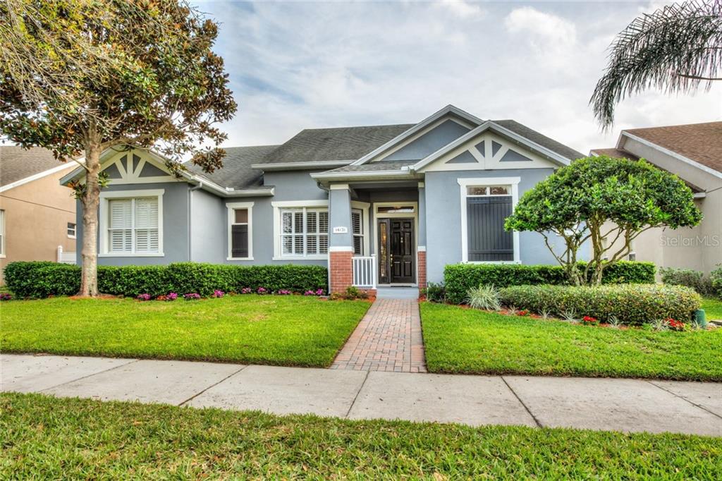 14131 Bluebird Park Road Windermere, FL 34786 - Photo 1 of 1 a front view of a house with a yard
