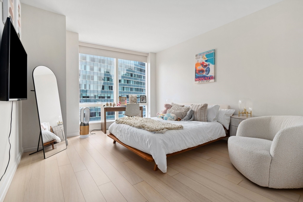 1 Franklin Street, Unit 2507 Boston, MA 02110 - Photo 12 of 37 a living room with furniture and a large window