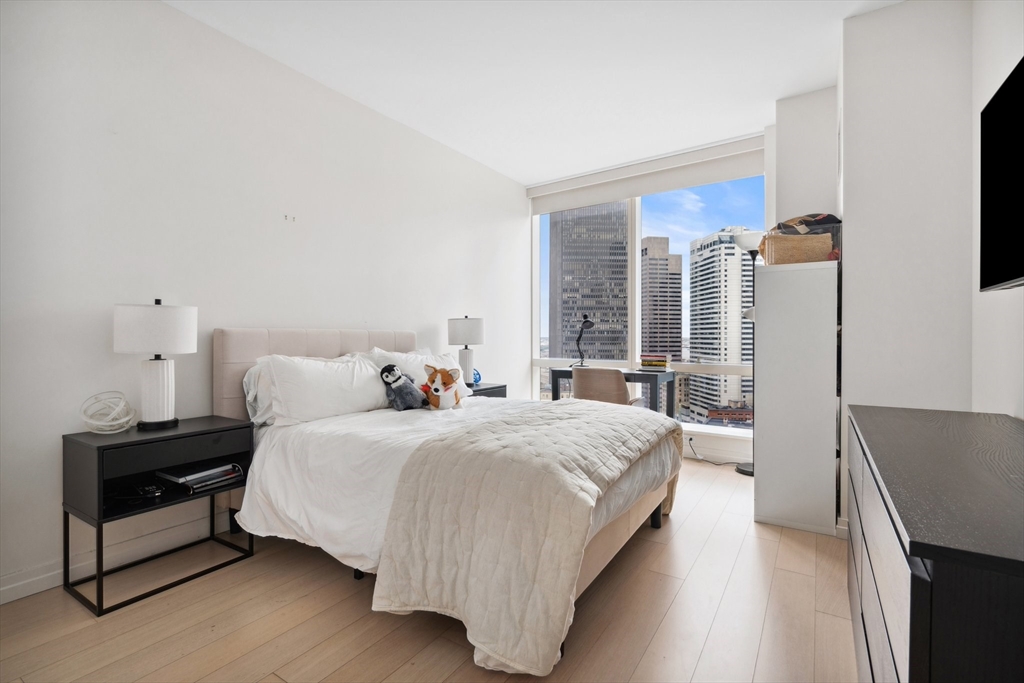 1 Franklin Street, Unit 2507 Boston, MA 02110 - Photo 17 of 37 a bedroom with a bed and wooden floor