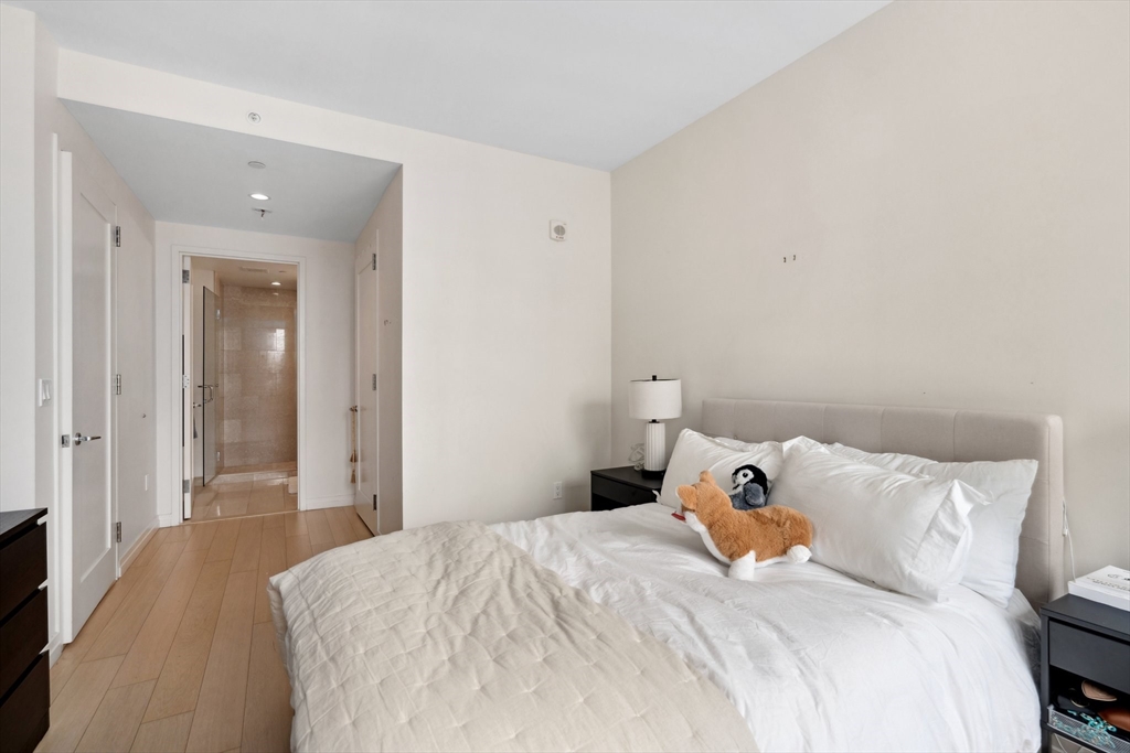 1 Franklin Street, Unit 2507 Boston, MA 02110 - Photo 20 of 37 a bedroom with a bed and a mirror