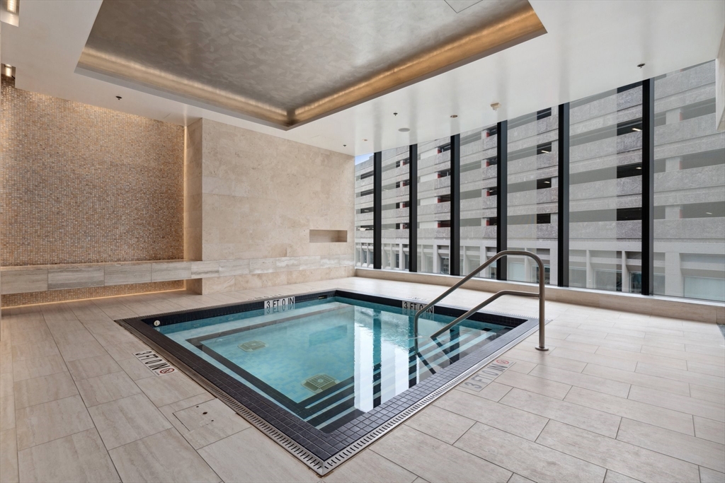 1 Franklin Street, Unit 2507 Boston, MA 02110 - Photo 23 of 37 a view of a swimming pool with a bench