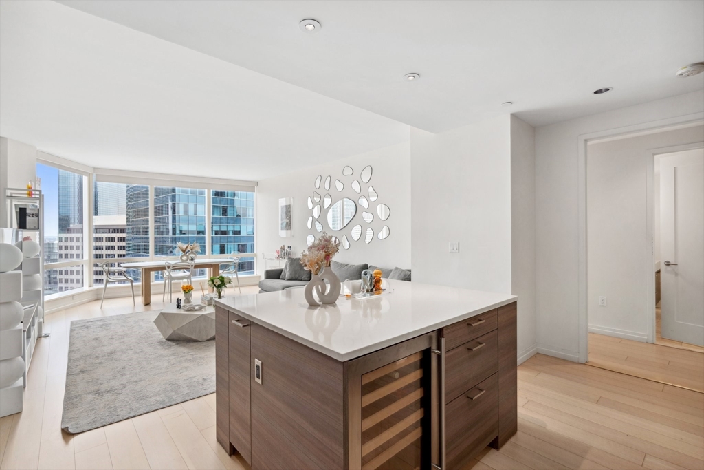 1 Franklin Street, Unit 2507 Boston, MA 02110 - Photo 6 of 37 a kitchen with a sink and living room