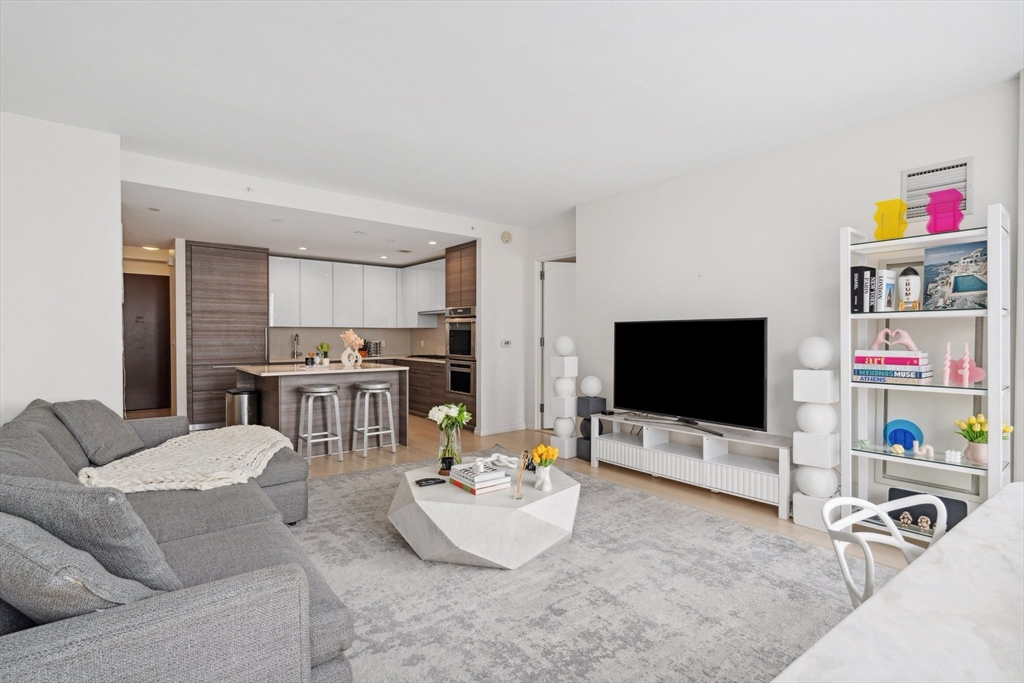 1 Franklin Street, Unit 2507 Boston, MA 02110 - Photo 7 of 37 a living room with furniture and a flat screen tv