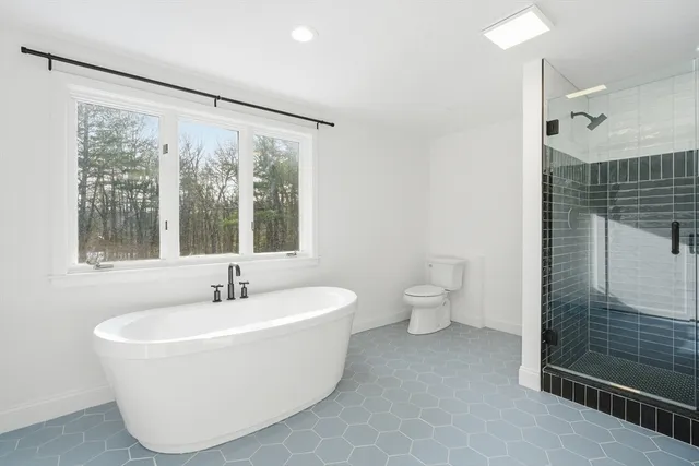 a white bath tub sitting next to a toilet