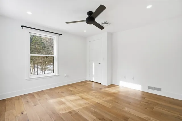a view of empty room with ceiling fan