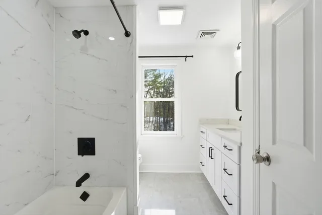 a bathroom with a bathtub and a shower