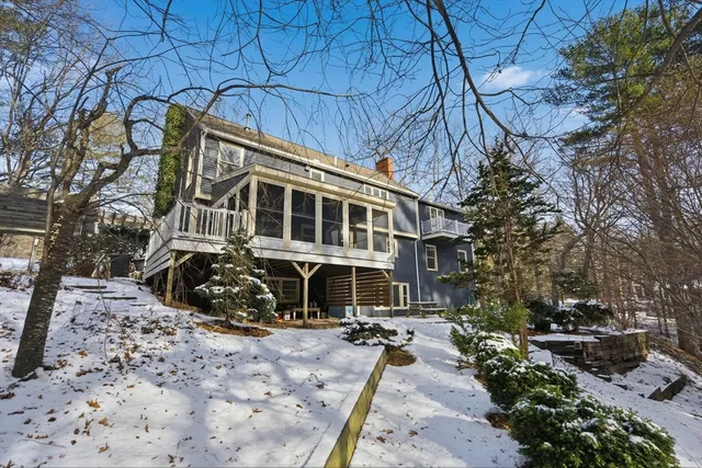 a view of a house with a yard covered with snow