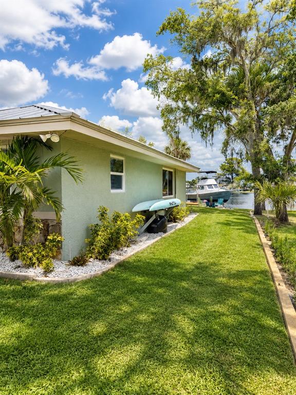 5431 Foley Square New Port Richey, FL 34652 - Photo 2 of 39 a swimming pool with outdoor seating and garden