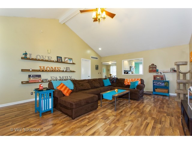 212 Chicago Road Oswego, IL 60543 - Photo 3 of 10 a living room with furniture and a wooden floor