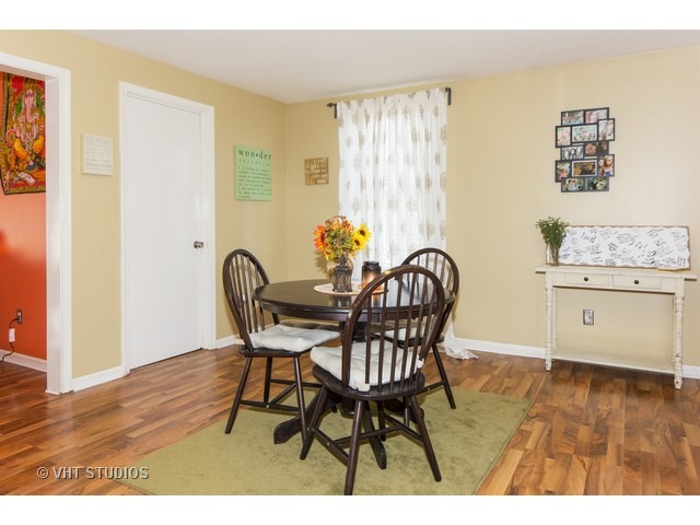 212 Chicago Road Oswego, IL 60543 - Photo 4 of 10 a view of a dining room with furniture and wooden floor