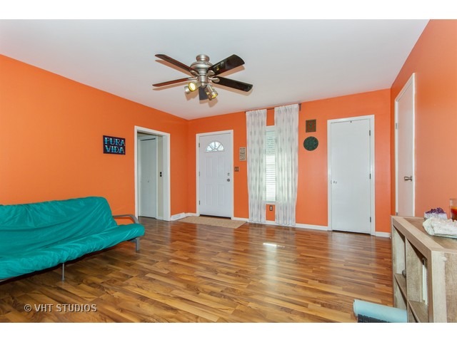 212 Chicago Road Oswego, IL 60543 - Photo 5 of 10 a view of a livingroom with a ceiling fan and window