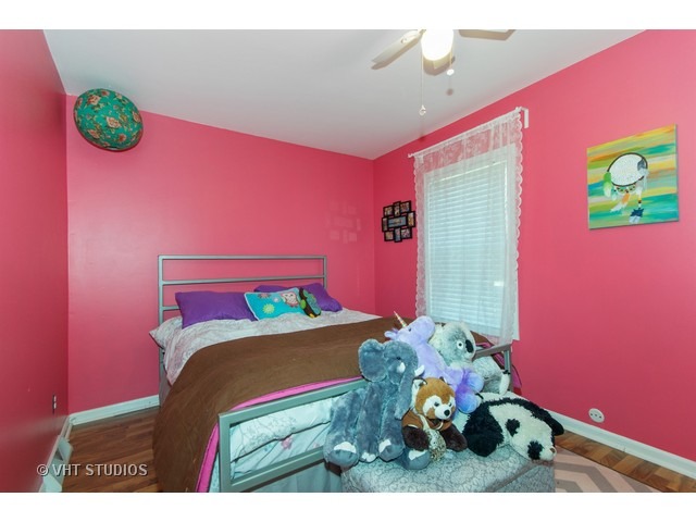 212 Chicago Road Oswego, IL 60543 - Photo 7 of 10 a bedroom with a bed and a couch