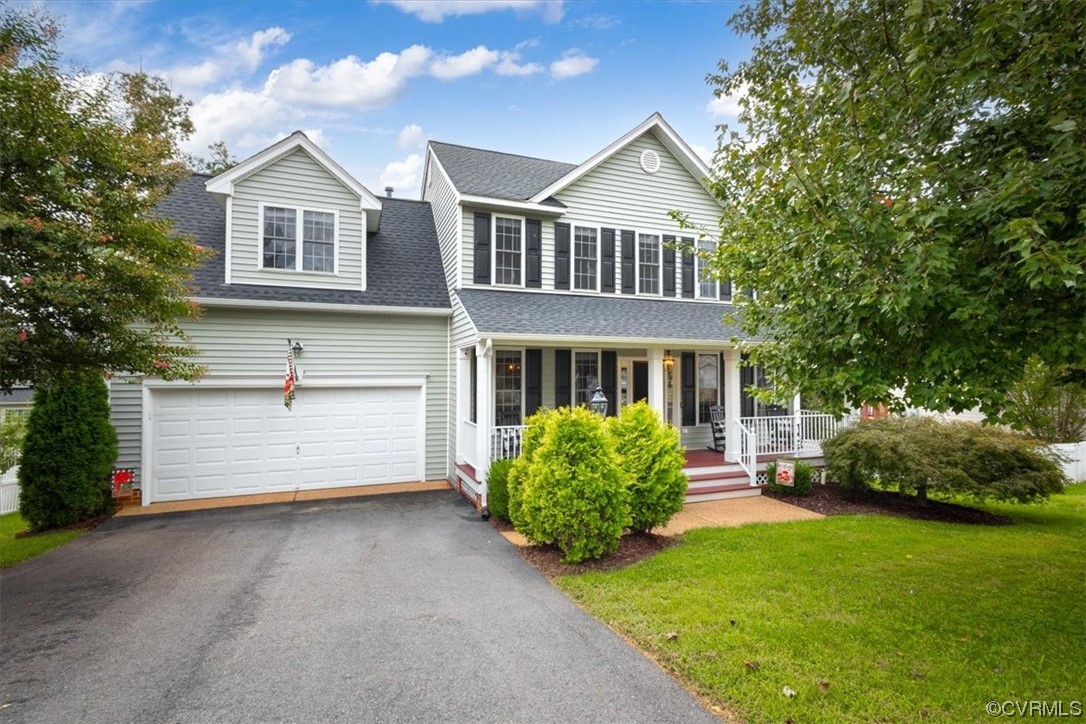 a front view of a house with a garden and plants