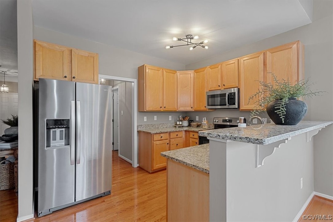 14825 Windjammer Drive Midlothian, VA 23112 - Photo 16 of 47 a kitchen with a refrigerator a stove cabinets and a dining table
