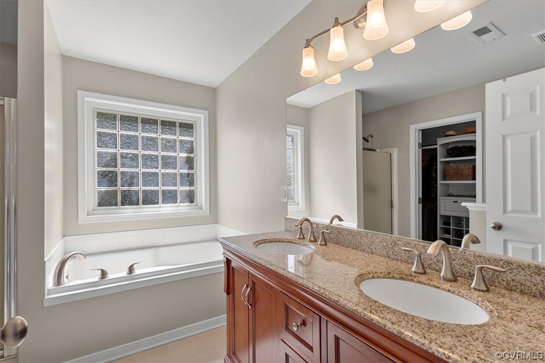 14825 Windjammer Drive Midlothian, VA 23112 - Photo 24 of 47 a bathroom with a granite countertop sink a large mirror and a bathtub