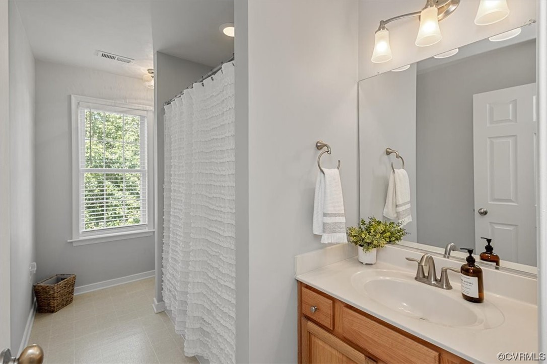 14825 Windjammer Drive Midlothian, VA 23112 - Photo 28 of 47 a bathroom with a sink a vanity and a mirror