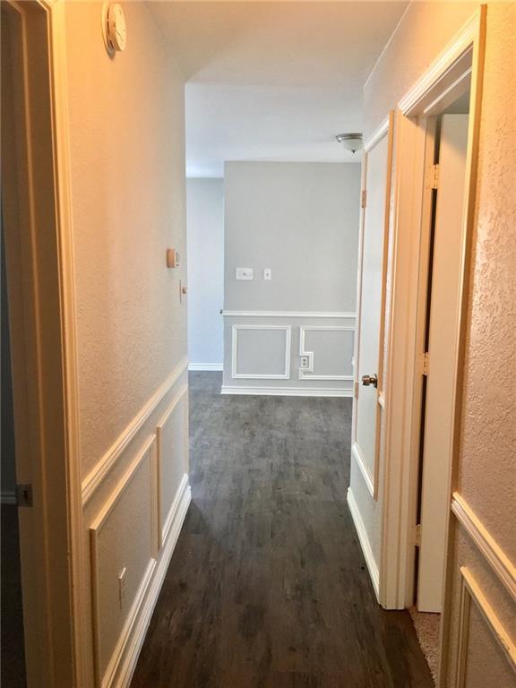 1005.5 Pine Street, Unit 1005 5 McKinney, TX 75069 - Photo 11 of 11 a view of an empty room with wooden floor and a window