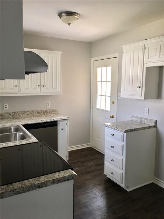 1005.5 Pine Street, Unit 1005 5 McKinney, TX 75069 - Photo 4 of 11 a kitchen with granite countertop a sink and a stove