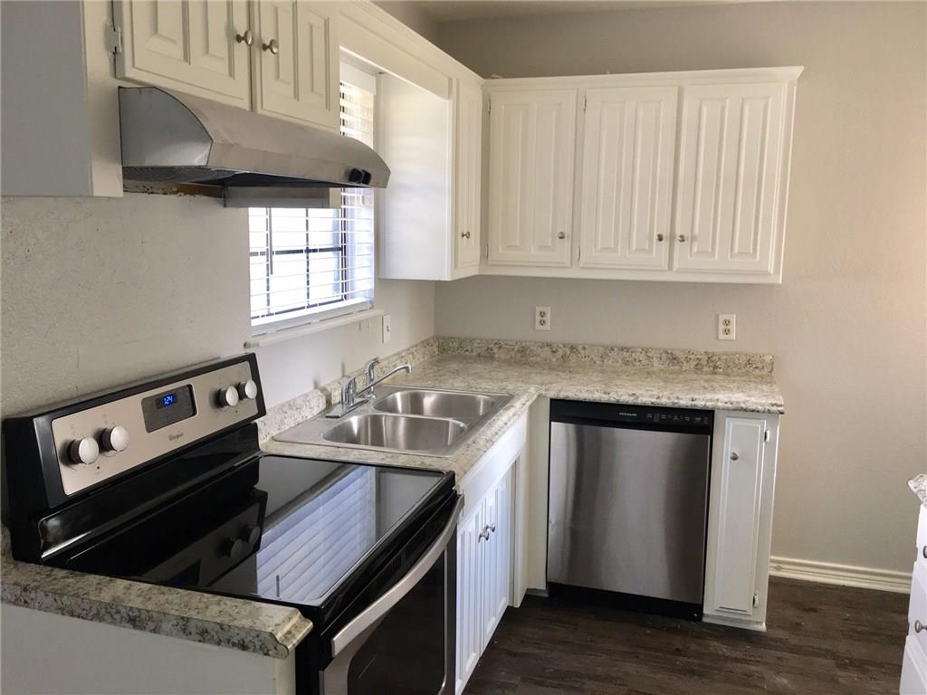 1005.5 Pine Street, Unit 1005 5 McKinney, TX 75069 - Photo 5 of 11 a kitchen with stainless steel appliances granite countertop a sink stove and cabinets