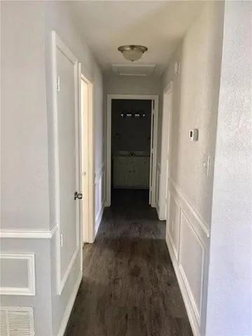 a view of a hallway with a wooden floor