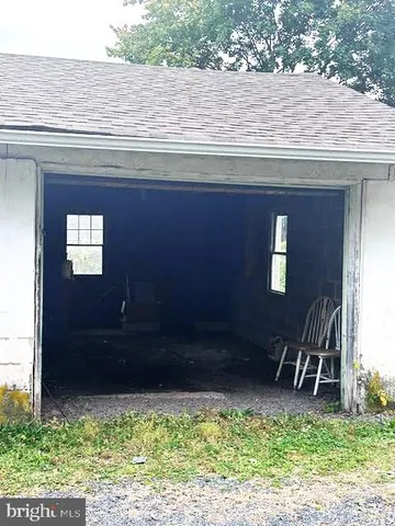 a backyard of a house with yard and outdoor seating