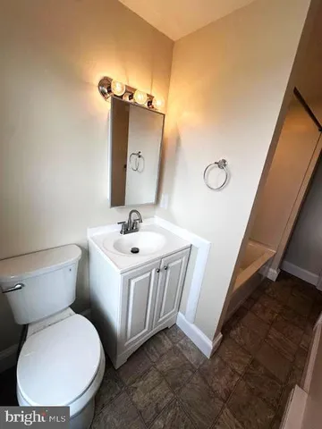 a white toilet sitting next to a bathroom sink