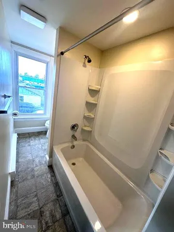 a bathroom with a bathtub and a shower