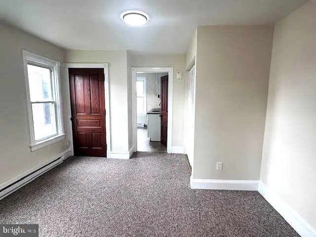 an empty room with windows and closet