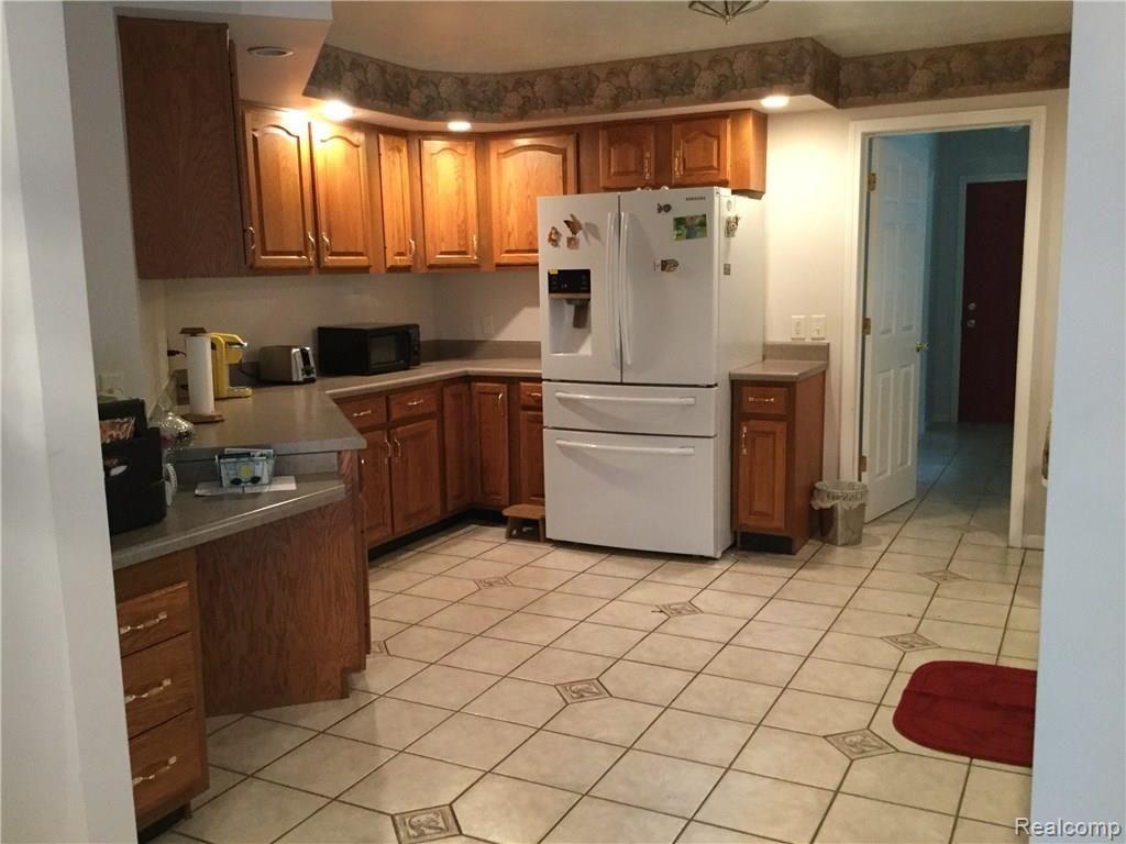 Kitchen with oak wood cabinets and ceramic flooring
