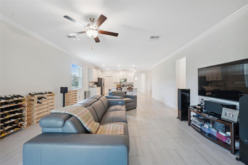 16787 Shell Bay Drive Land O Lakes, FL 34638 - Photo 13 of 54 a living room with furniture and a flat screen tv