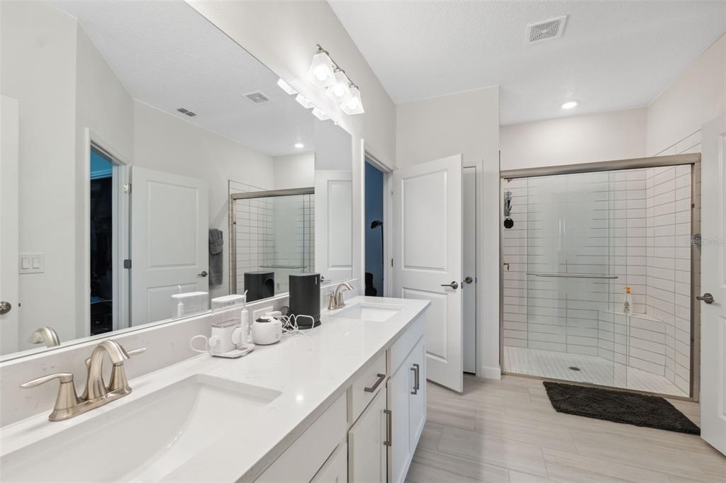 16787 Shell Bay Drive Land O Lakes, FL 34638 - Photo 14 of 54 a bathroom with a double vanity sink mirror and shower