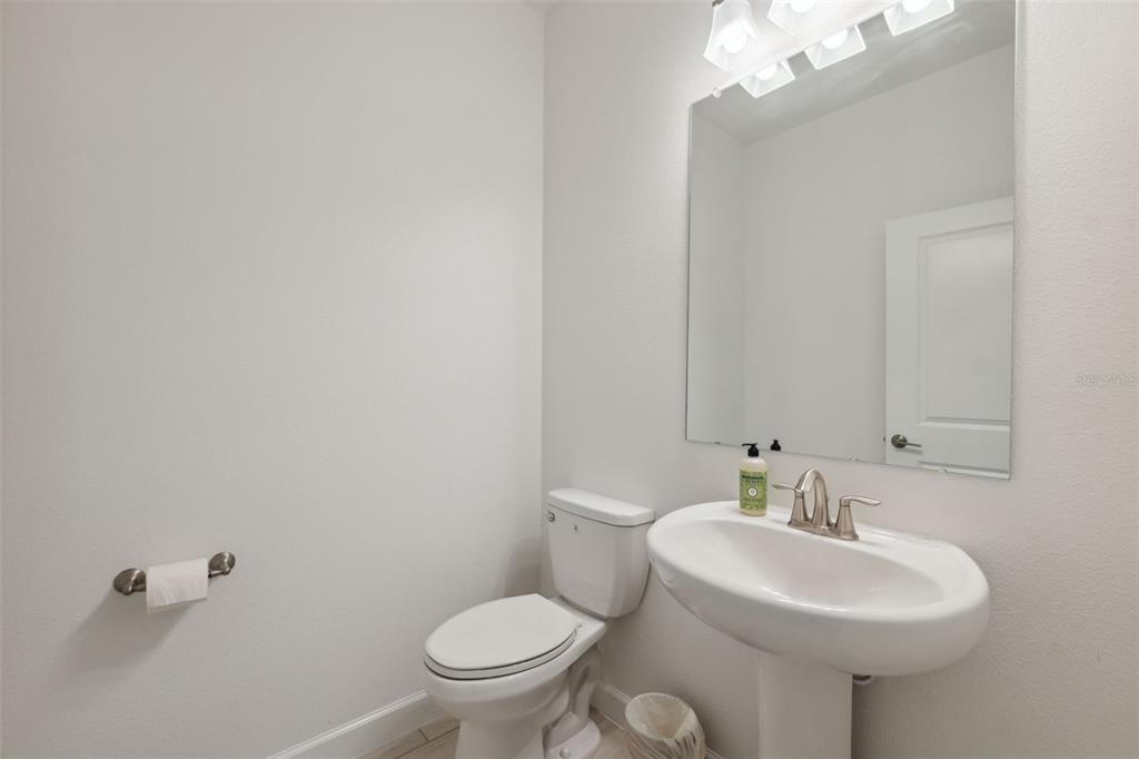 16787 Shell Bay Drive Land O Lakes, FL 34638 - Photo 16 of 54 a bathroom with a sink a toilet and mirror