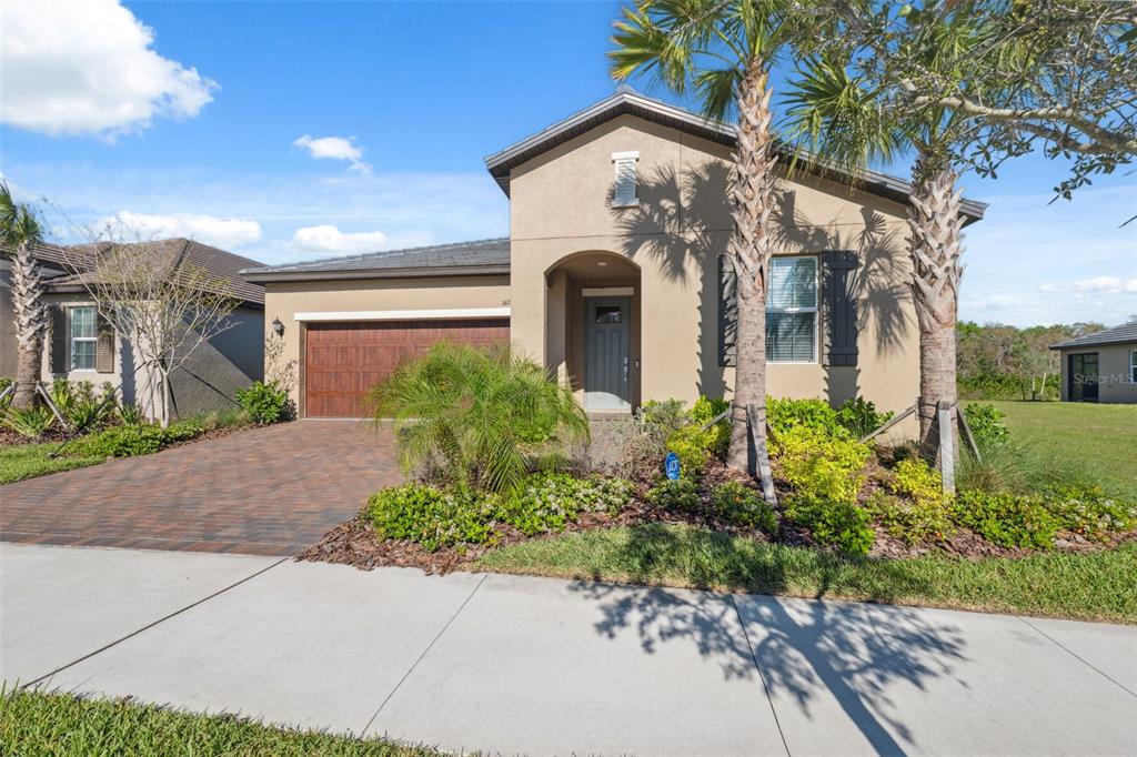 16787 Shell Bay Drive Land O Lakes, FL 34638 - Photo 27 of 54 a front view of a house with garden