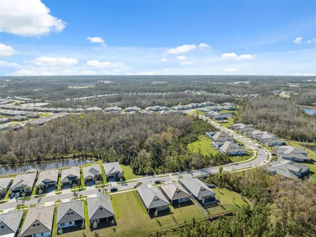 an aerial view of a residential houses with outdoor space