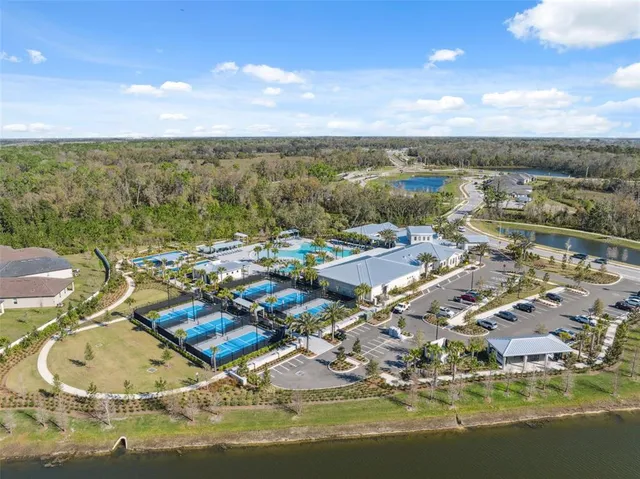 an aerial view of a swimming pool patio and outdoor seating