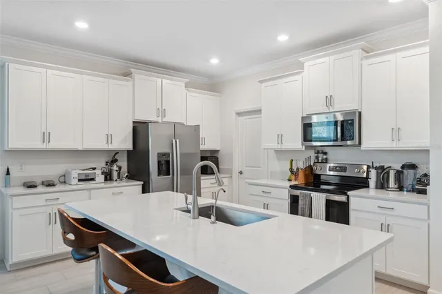 a kitchen with refrigerator and cabinets