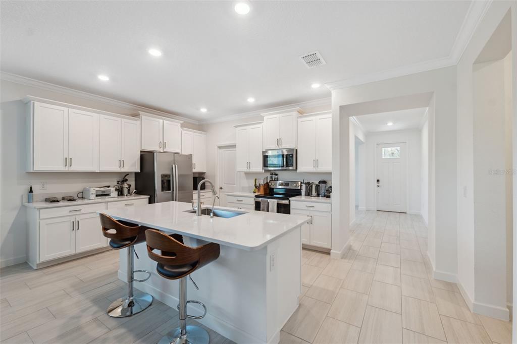 16787 Shell Bay Drive Land O Lakes, FL 34638 - Photo 8 of 54 a kitchen with refrigerator and cabinets