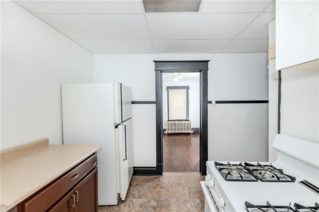 926 Oak Street, Unit 2 Indiana, PA 15701 - Photo 3 of 7 a kitchen with a refrigerator and a stove