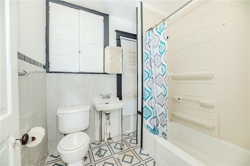 926 Oak Street, Unit 2 Indiana, PA 15701 - Photo 4 of 7 a bathroom with a toilet and a shower curtain