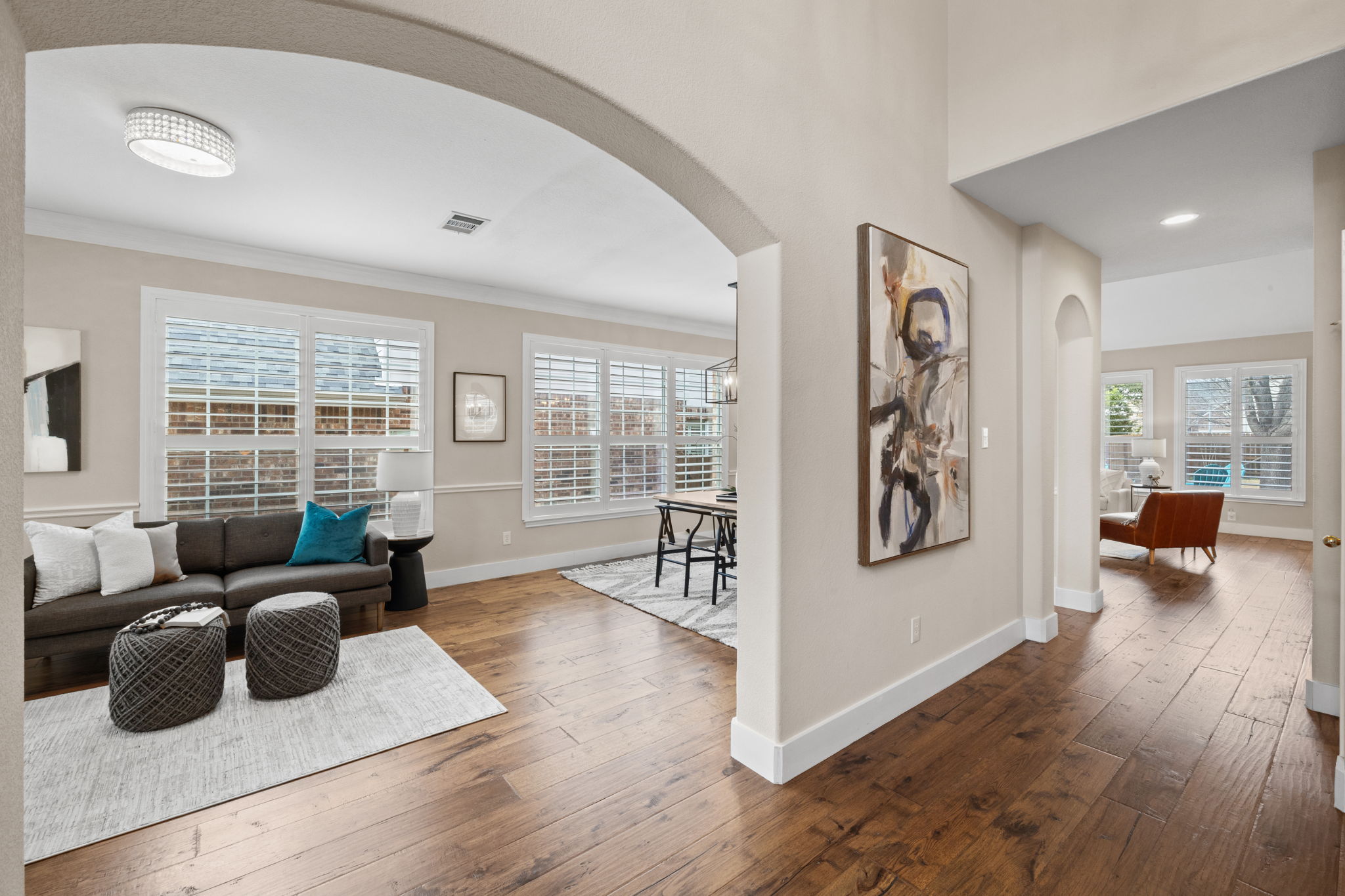 8112 Cobblestone Austin, TX 78735 - Photo 5 of 33 Living room featuring arched walkways, dark wood-style floors, ornamental molding, and plenty of natural light