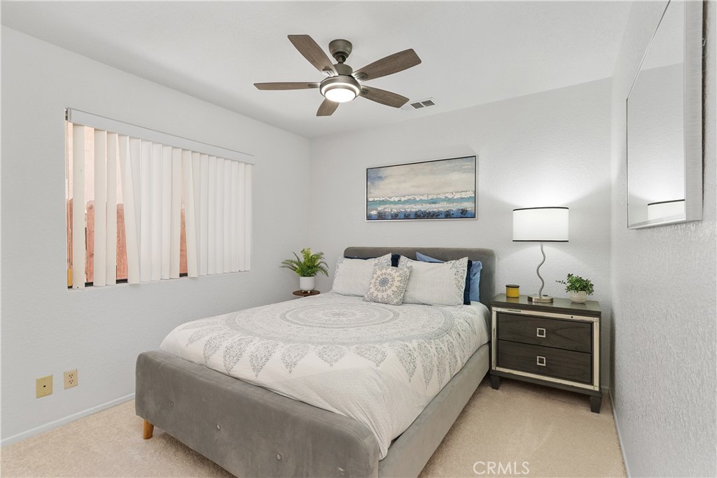 78680 Saguaro Road La Quinta, CA 92253 - Photo 16 of 30 a bedroom with a bed and a painting on the wall