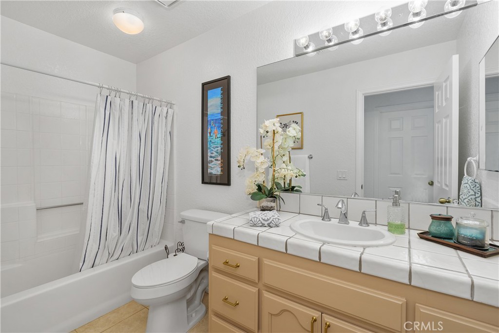 78680 Saguaro Road La Quinta, CA 92253 - Photo 17 of 30 a bathroom with a granite countertop sink toilet and shower