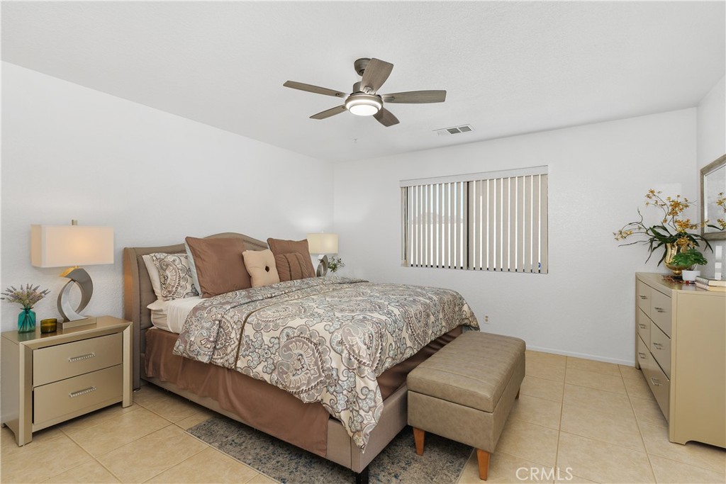 78680 Saguaro Road La Quinta, CA 92253 - Photo 19 of 30 a bedroom with bed couch and window